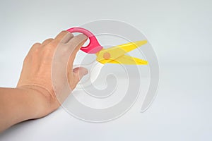 Isolated woman holds zigzag scissors for cutting with left hand