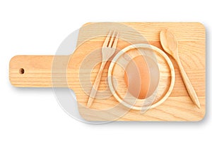 Isolated Wooden Kitchen Utensilsand food concept, Cutting chopping board, spoon, fork and chicken egg on small round dish saucer