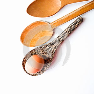 Isolated Wooden Kitchen Utensilsand and healthy food concept, One brown chicken egg on wood spoon with white background-selective