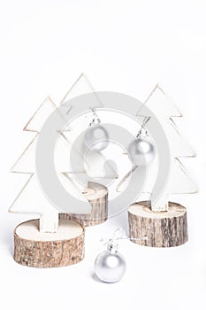 Isolated wooden white Christmas tree decorations with ornaments on white background, composition with bright Christmas trees