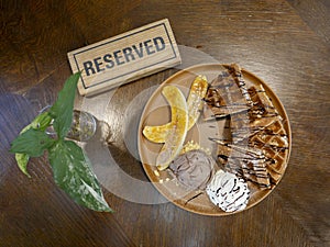 The isolated wording of Reserved on the wooden table and food