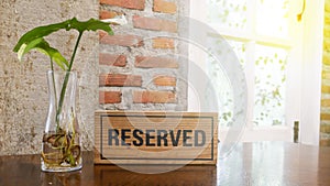 The isolated wording of Reserved on the wooden table and yellow light background