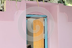 Isolated yellow door of a violet and blue house