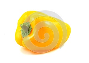 Isolated yellow pepper stands on the table on a white background