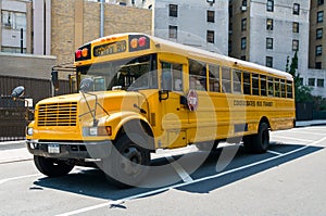 Isolated yellow USA american school bus on street in city