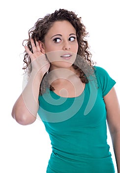 Isolated young funny woman in green listening for special sales