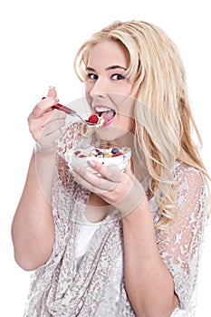 Isolated young girl eats cereals