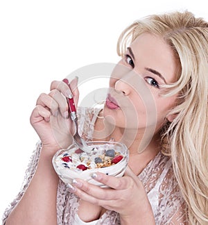 Isolated young girl eats cereals