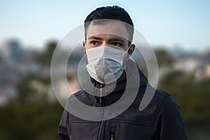 Isolated young man wearing mask looking towards