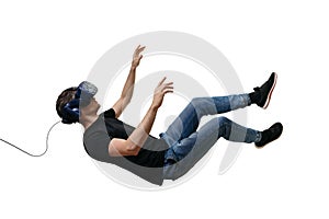 Isolated young men falling in zero gravity space while using virtual reality glasses on white background