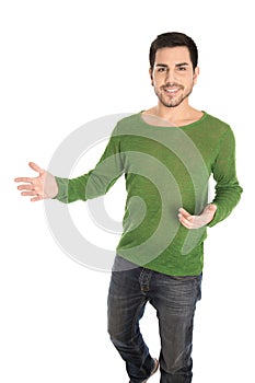 Isolated young smiling casual man making hand gesture for sales