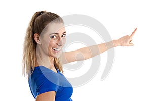 Isolated young woman in blue shirt presenting with her finger on