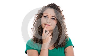 Isolated young woman in green thinking about her future.