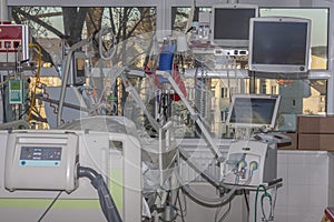 Isolation room in intensive care unit. Patient connected to medical ventilator and dialysis machine . Place where can be treated