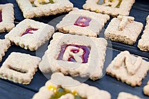 Isomalt stained glass cookies with letters. Christmas or X-mas baking culinary background, cooking recipe