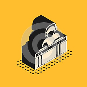 Isometric DJ wearing headphones in front of record decks icon isolated on yellow background. DJ playing music. Vector