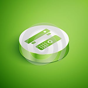 Isometric Multimedia and TV box receiver and player with remote controller icon isolated on green background. White