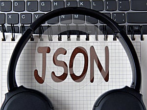 ISON -word on white notepad with keyboard and headphone background