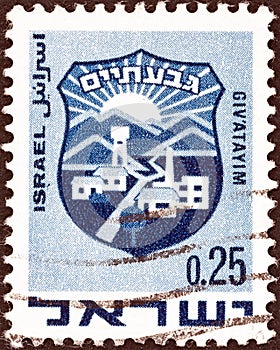 ISRAEL - CIRCA 1969: A stamp printed in Israel shows coat of arms of Giv`atayim, circa 1969.