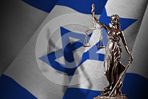 Israel flag with statue of lady justice and judicial scales in dark room. Concept of judgement and punishment