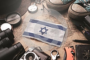 Israel Flag Between Traveler`s Accessories on Old Vintage Map. Tourist Destination Concept