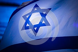 Israel flag waving cloudy sky background sunset photo