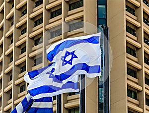 Israel flags on background of building in Tel Aviv Magen David sign, Israel independence day, David`s star