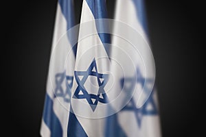 Israel flags with a star of David over dark gray background. Banner with place for text.