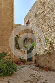 Israel-Jerusalem-12-05-2019 view of an old romantic courtyard in the center of Jerusalem, with planters.