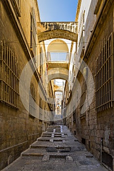 Israel, Jerusalem, View of a narrow street that rises with its unique stairs and the yellow stones of the old buildings