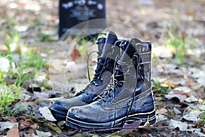 Israel Memorial day, Yom HaZikaron, Concept. Israeli soldier boots on the graveyard in the background a monument photo