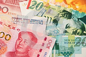 Israel Shekel and China Yuan Renminbi currency banknotes. ILS CNY RMB photo