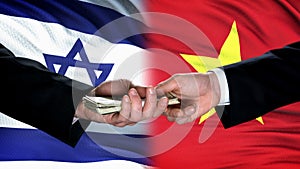 Israel and Vietnam officials exchanging money, flag background, partnership