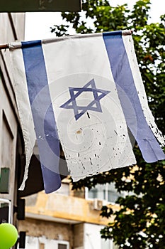 Israeli flag hanging on a building door in Tel Aviv, Israel