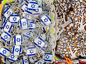 Israeli flags keychains or trinkets and souvenirs wooden small trees for sale at street market