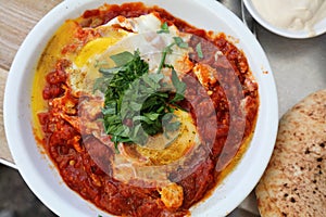 Israeli food - shakshuka poached eggs