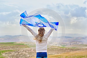 Israeli jewish little girl with Israel flag back view.