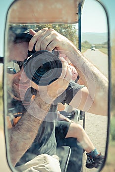 Israeli man reflected on the side mirror of an electric golf cart