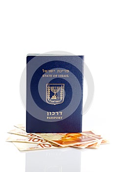 Israeli passport with 100 shekel banknotes isolated on white background. Close-up