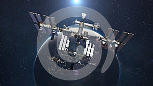 The ISS flies on the background of the blue planet Earth with the light of the sun. Space mission and space exploration