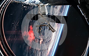 ISS in orbit of planet Earth. View from porthole. Solar system