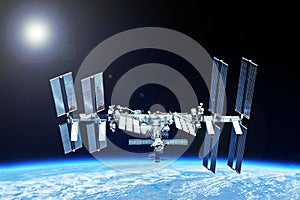 ISS over the planet, against the background of clouds. Elements of this image furnished by NASA