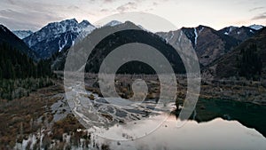 Issyk mountain lake with mirror water at sunset.