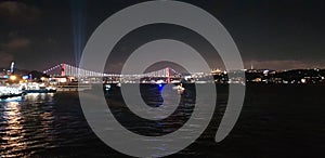 istanbul besiktas at night, the bosphorus bridge in darkness with its new name 15 july cities bridge photo