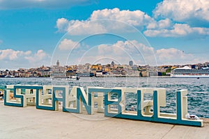 Istanbul city sign monument is seen on sunny day with cityscape in the background over the Bosphorus channel. Symbol of Istanbul