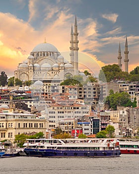 Istanbul city view at Eminonu overlooking the Golden Horn with ferries, ferry terminals, and Suleymaniye Mosque, Turkey