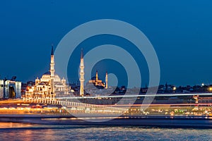 Istanbul cityscape - panoramic scenic view of mosque with ferry boat at sunset. Long exposure landscape of Istanbul at night