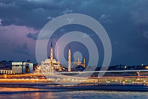 Istanbul dramatic cityscape - panoramic scenic view of mosque with ferry boat during storm with lightning over Suleyman Mosque.