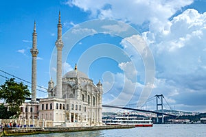 Istanbul landscape. Istanbul`s populer touristic destination Ortakoy Mosque and Bosphorus Bridge view. Cloudy sky in summer day