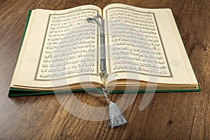 Istanbul, Turkey - April 5, 2015; A Quran book opened with a rosary. Quran - holy book of innocent Muslims breadth of all Muslims